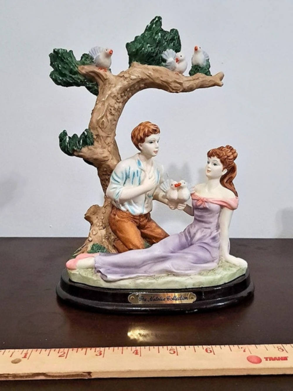 figurine of a courting couple with white doves under tree The Natalie Collection